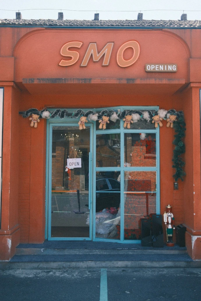 A store, "smo", has an "opening" sign.